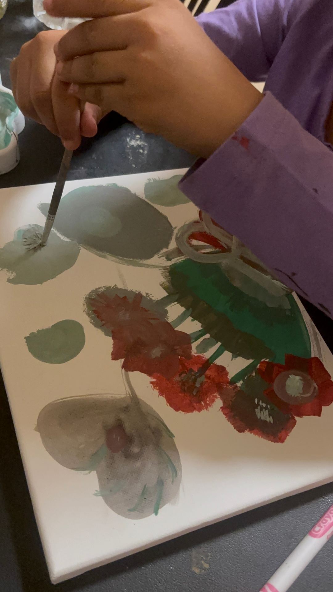 Amillie painting delicate flowers on canvas
